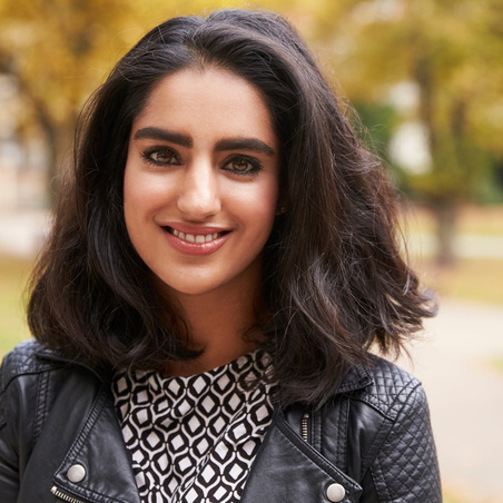 Portrait Of British Muslim Woman In Urban Park